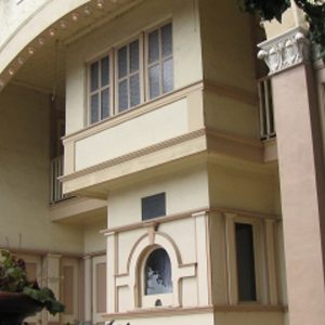 A side angle of the Sesser Opera House, only really the ticket counter is visible other than several windows.