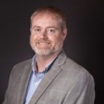 Photo of Jason Ashmore, Mayor of Sesser, a man with short light brown hair and a slightly shaggy beard that is lighter near the bottom.